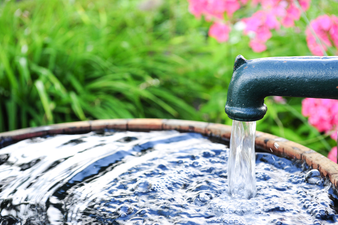 A hand is held out, catching a stream of water