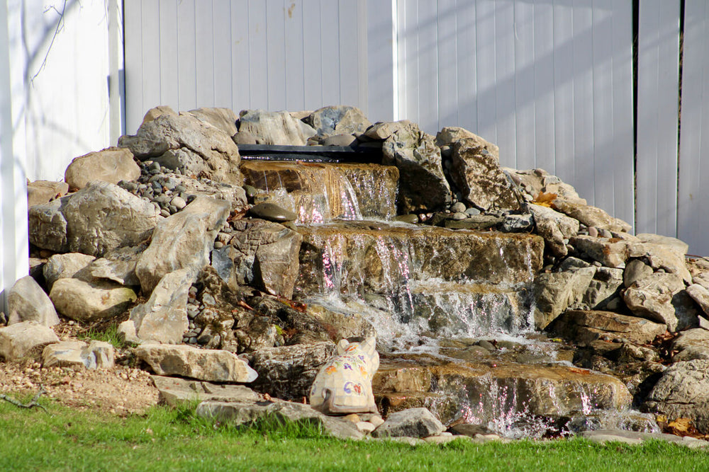 A pondless, modern water feature in a front yard