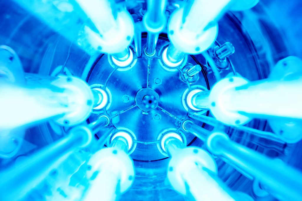 The inside of a lamp with several bulb tubes arranged in a circle
