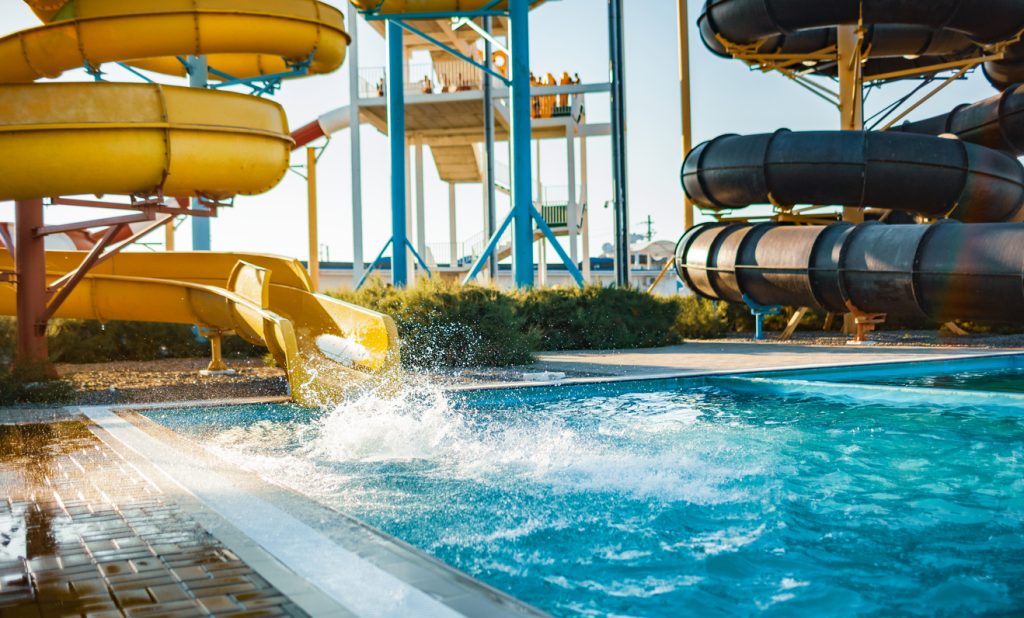 Curly water slides in a water park emptying into a UV sterilized pool