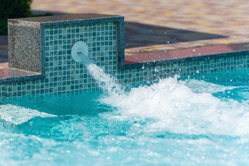 A water spout in a pool, sending UV sterilized water into the pool