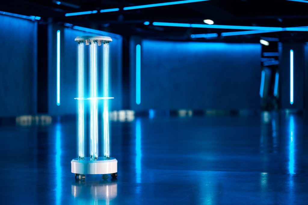 A UV light disinfection system shines brightly in a dark room