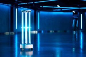 A UV light disinfection system shines brightly in a dark room